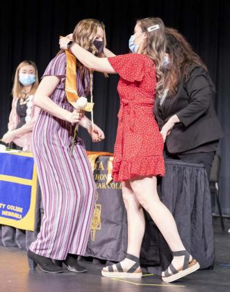 Alysen Daniels receives a gold stole during the PTK induction ceremony Sunday at North Platte Community College. Heather Johnson