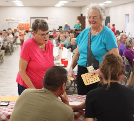 When Sue Bonesteel (left) and Judy Ridenour got Bingos at the same time, they opted to split the $20 pot instead of playing “name that tune” to determine one winner. Also pictured are Bingo callers Ryan and Shelby Ridenour. Gerri Peterson