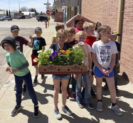 2nd graders plant flowers at elementary