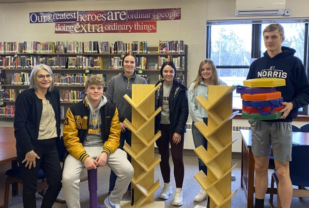 Mullen High School National Honor Society members used the Scholastic Bookfair money that they raised to purchase bookshelves, floor seating and a wobble chair for the school libraries. Pictured l-r: Media Specialist Mrs. Licking, Ethan Hardin (sitting on the wobble chair), Jadyn Andersen, Bella Brown, Lauren Schoonveld, Clayton Moore (holding the floor seats). NHS members not pictured: Deacon DeNaeyer, Chase Gracey, Ashlyn Simonson. Kara Connealy