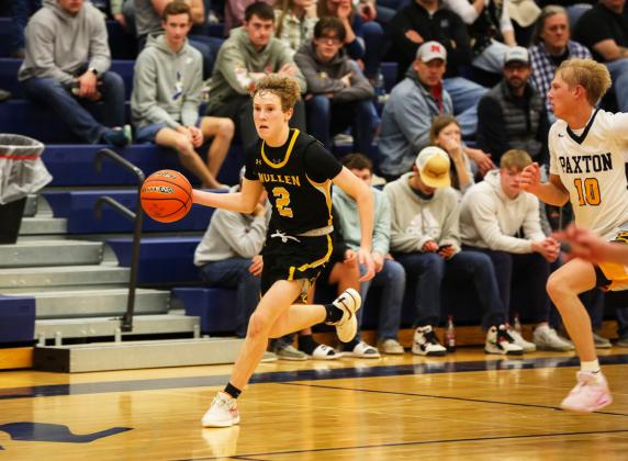 Brandon Hardin dribbles down the court against Paxton. Megan Andersen