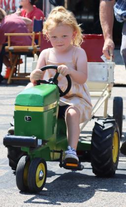 Wrenley Call tries out pedal tractor pulling. Gerri Peterson