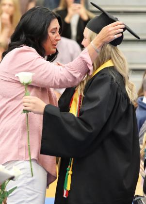 Hayley Donohoe and her mom, Shauna, share a moment during the flower presentation.