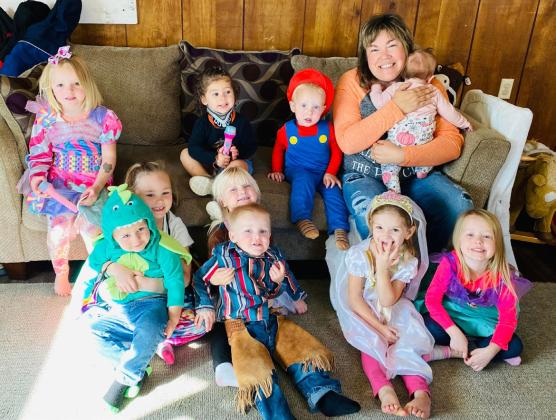 Lots of Love Day Care, back l-r: Ryann Walz, Ellianna Collins, Arthur Polt, Lori Freeze holding Adylee McIntosh. Front: Brogan Jewell holding Chasin McIntosh, Violet and Aiden Stichka, Ryhme Pettit, Aurora Polt.