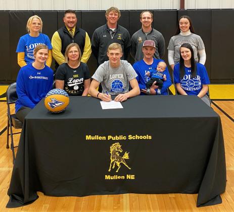 Mullen High School senior Clayton Moore signed his letter of intent to play basketball at the University of Nebraska-Kearney next year on Monday, Nov. 14. Pictured back, l-r: Tierston Moore, MPS Superintendent Chris Kuncl, MHS Boys Basketball Head Coach Brad Wright, MHS Boys Basketball Assistant Coach Daniel Young, Mercedes Garner. Front: Samantha Moore, Jennifer Moore, Clayton Moore, Lance Moore holding Cru Moore and Harlee Fischer.