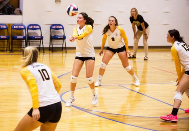 Allie Boyer passes up the ball at the Arthur triangular while teammates Taylor Svoboda, Jordyn McDowell and Shelby Welsh and Head Coach Jennifer Moore look on. Megan Andersen