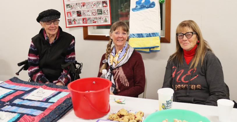 Darlene Hall, Glenda Phipps and Deb Cox at the Sandhills Junior Rodeo Bible Camp table.