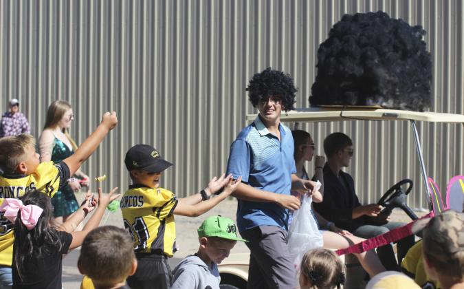 MHS sophomore Jacob Walker watches as his sister Natalee Walker catches the candy he threw her way during the Homecoming parade last Friday, Sept. 29.