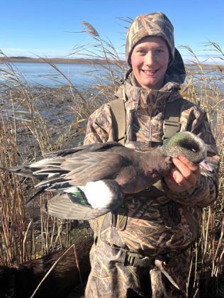 Teal Peterson and a wigeon on a duck hunt this fall.