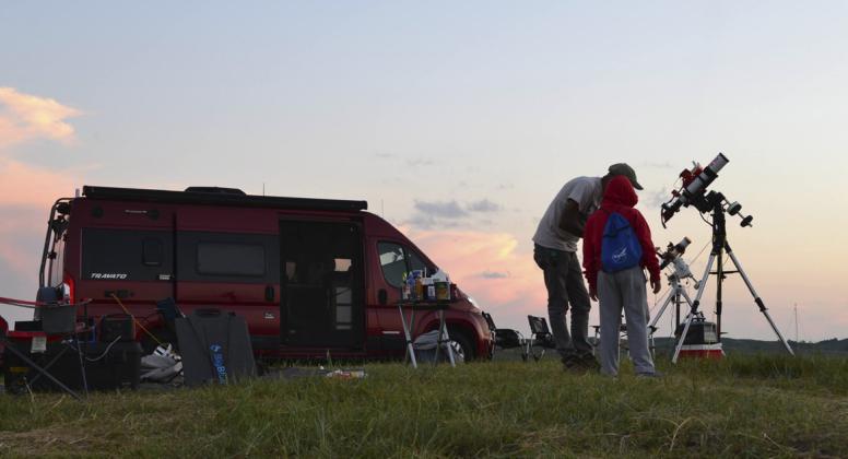 Astrophotographer Kumar Challa from St. Louis shows some of his work to a budding astronomer on the final night of the Nebraska Star Party. Carson Vaughan