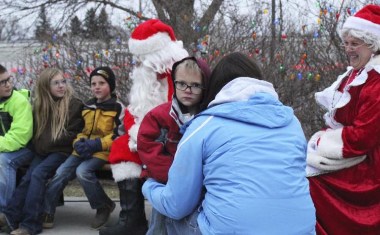 Trent Cox wanted nothing to do with Santa last Thursday when the Mullen Commercial Club brought him to town. Trent clung onto his mom, Erin Cox, while his older siblings Cort, Olivia and Luke talked to Santa.