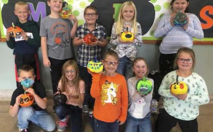 Second graders show off pumpkins