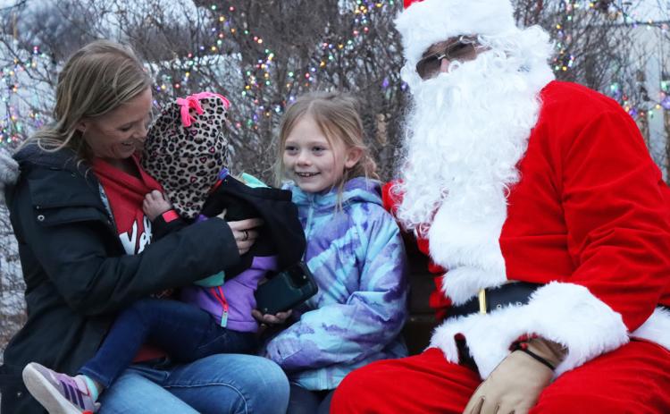 Wrenley Call wouldn’t even look at Santa, she just hid her face in mom Tara’s shirt, while sister Brystol was all smiles.