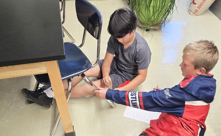 The Mullen 6th graders have been working on a measuring unit in Mrs. Jewell’s class. They had a classroom scavenger hunt one day last week, doing a lot of moving and searching. Pictured are Lorenzo Gonzalez and Caleb Deibler. Tawnee Jewell