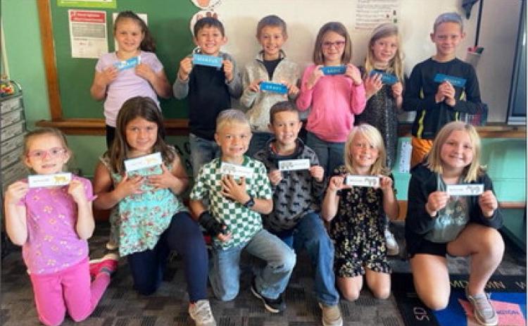 A big thank you to Cathy Nichols for making bookmarks for the elementary students! The second graders are pictured with their personalized bookmarks. Pictured back, l-r: Kaleah Heaton, Marcus Lattin, Grady Phipps, Sadie Hoyt, Marki Finney, Eli Barnes. Front: Anna Hessin, Zandra Hebbert, Killian Kearns, Holt Morrison, Daryl Deibler, Tatum Deibler. Emily Brown