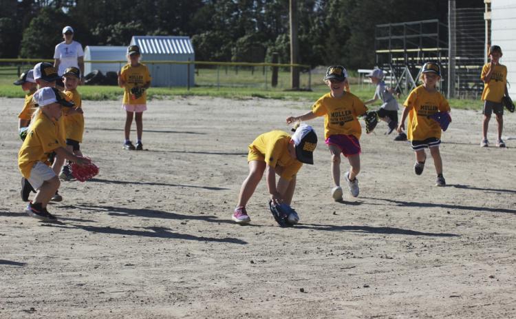 Harper Myers fields the ball during the t-ball game against Thedford on Monday, June 19, Dane Peterson