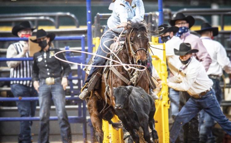 Kirby Eppert in action last week with Katie Mundorf standing in the box behind her. ProRodeo Photos by Joe Duty
