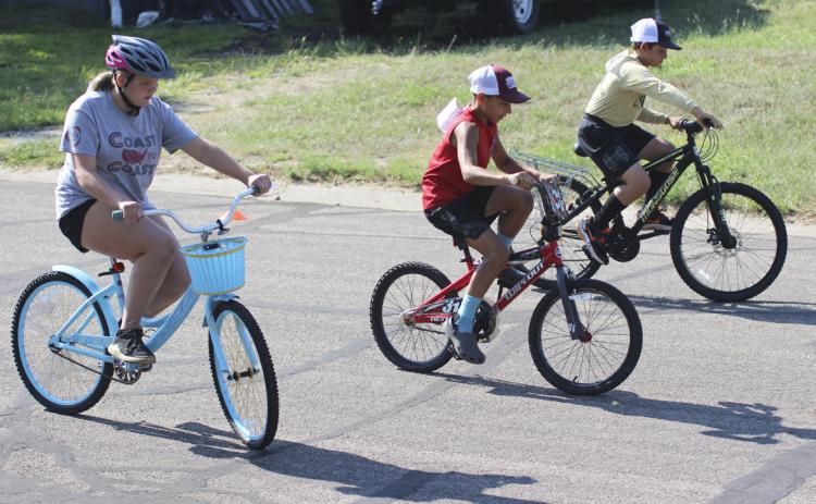 L-r: Maci Walz, Gunner Brown and Colin Connealy compete in the 4th-6th grade slowest race at the Bicycle Rodeo last Wednesday. Gerri Peterson