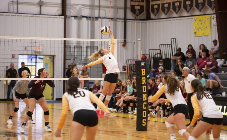 Setter Alli Loughran tips the ball over the net last Friday against Twin Loup. Megan Andersen