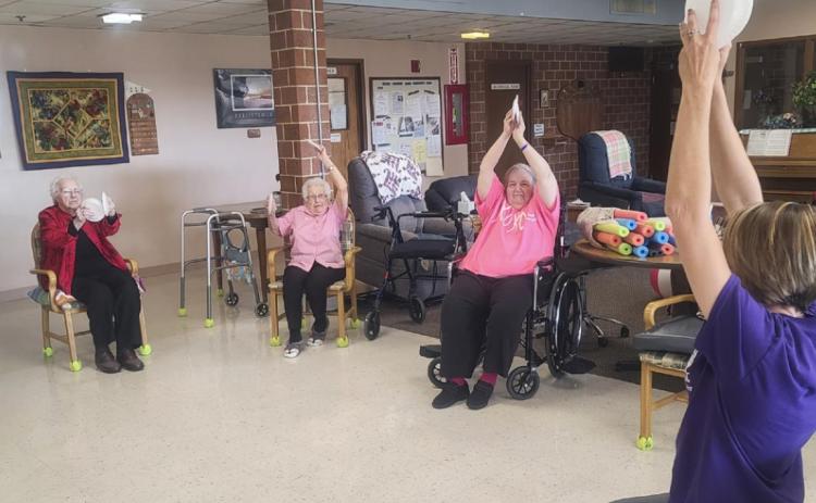 Rebecca Welsh doing restorative upper body exercises with the residents, l-r: Minnie Mary Hamilton, Nadene Andersen and Ann Connell.