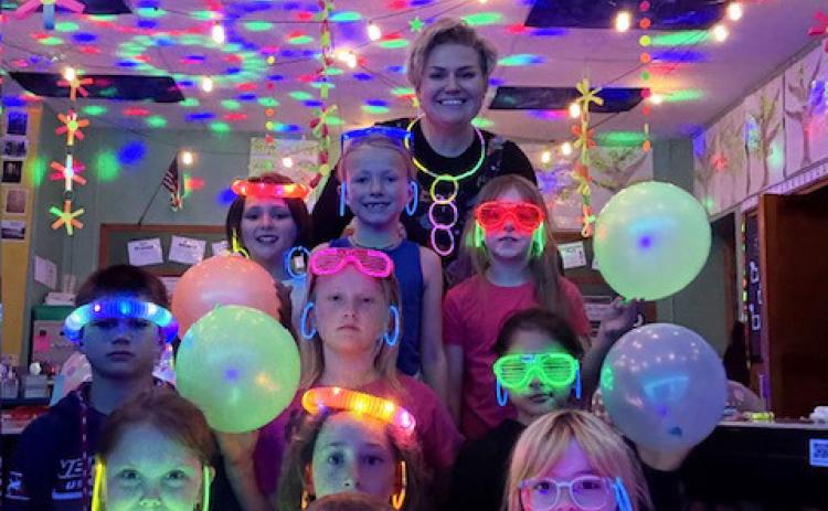 Miss Brown and the 2nd graders on their Glow Day last Thursday. Back row, l-r: Ellie Licking, Fallon Lee, Eve Ericksen. 2nd row: Tru Mundorf, Danielle Peterson, Abigail Gonzalez. Front: Aislynn Connealy, Trent Cox, Dailie Dent, Nora Pohot. courtesy photo
