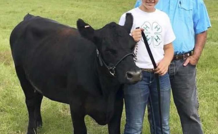 Izabella Brown with her grandpa Mike Connell at the 4-H Livestock Show. courtesy photo