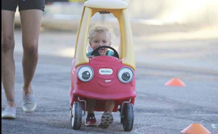 Burke Mundorf had a little help from his mom to power through the bicycle rodeo weave last Monday evening. Gerri Peterson
