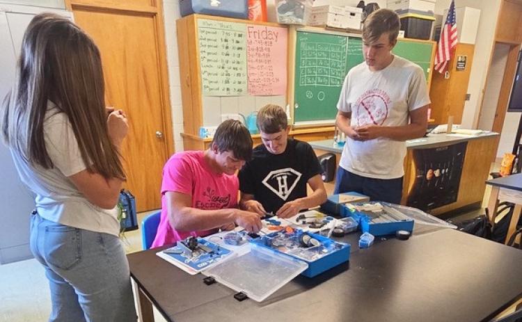 L-r: MHS juniors Toni Massey, Tate Kvanvig, Cayden Hampton and Jacob Walker at the VEX robotics STEM station. The STEM trailer was developed by Custer Public Power District and BD Medical to bring hands-on STEM stations to the rural schools that CPPD supplies power to. MHS gets four stations for 12 weeks at a time, every other year. Tawn Jewell