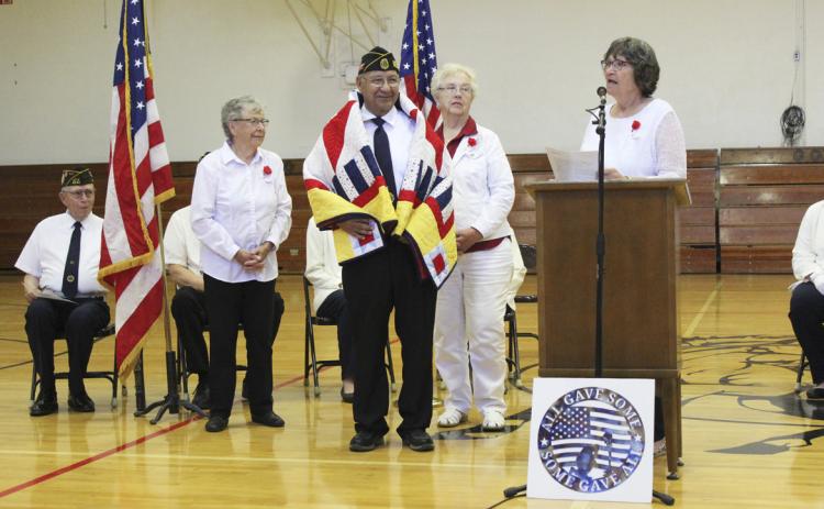 Don Younkin with his Quilt of Valor as Eva Crawford reads about his military experience. Also pictured standing are Sherron Sullivan (left) and Doris Starr who helped with the presentation.