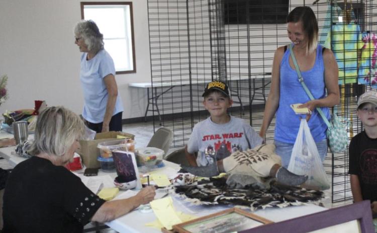 Sue Bonesteel and Val Simonson were busy helping people enter their Open Class exhibits last Thursday morning. Pictured are Sharilyn Bader and Jaxyn, Mishayla and Kayden Evans. Gerri Peterson