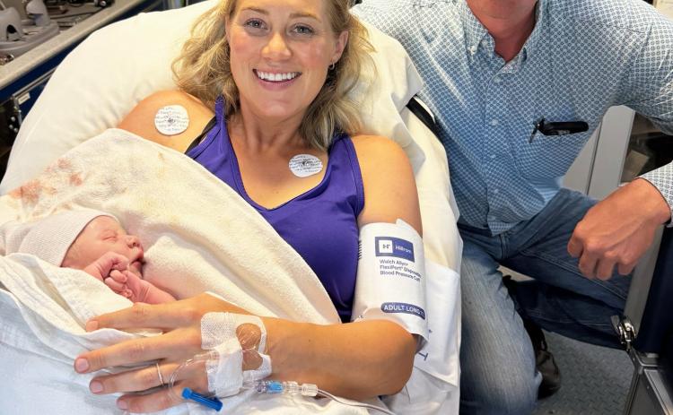 Jais and Jed Connealy with their newborn son Teddy who was born on Highway 2 in the Litchfield ambulance. courtesy photo
