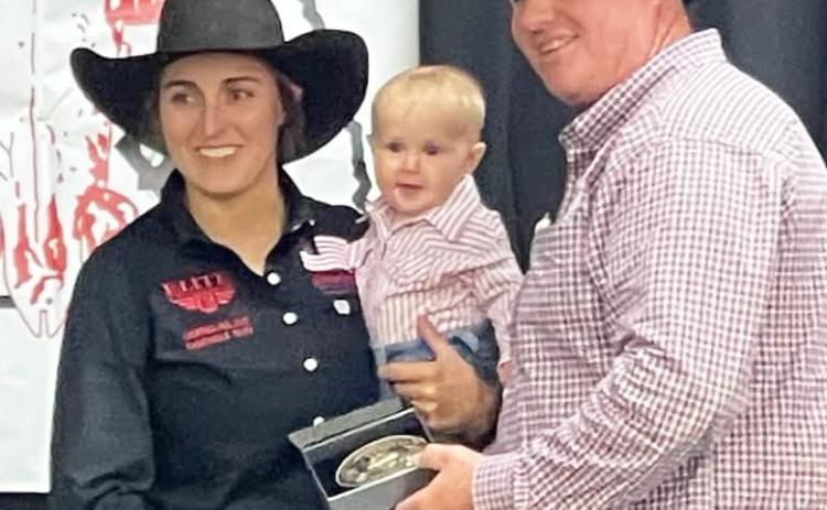 Brittni Bradley, holding her six-month-old daughter Josi, being awarded the All-Around. Traci McCully