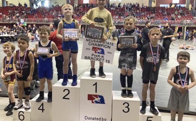 Grady Phipps stands on top of the podium last Sunday at the NEUSA State Wrestling meet. Steven Dent