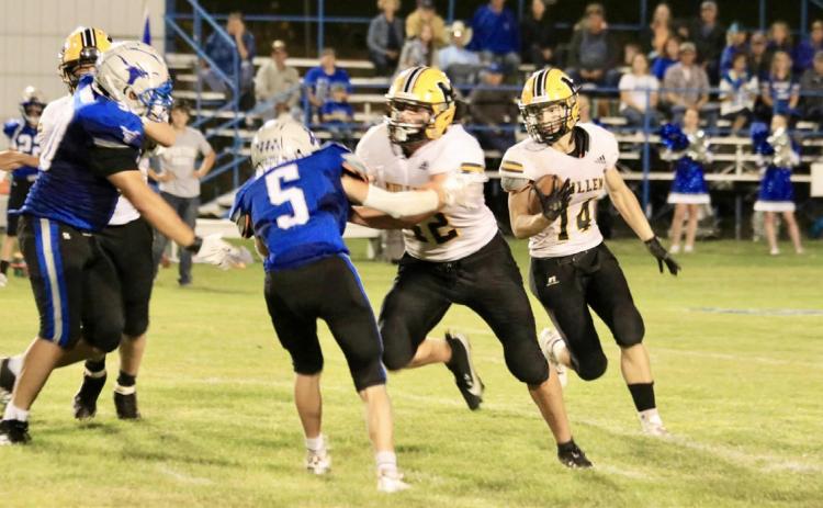 Alex Werner follows the block of Tate Kvanvig for more yardage last Thursday night in Hyannis. Carolee Brown