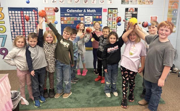 The first graders recently brought space to life in their classroom, creating solar systems! Pictured l-r: Doris Boland, Wyatt Greeley, Ryann Walz, Brogan Seeley, Wesley Simmons, Ryhme Pettit, Brystol Call, Austin Smith, Addison Mundorf, Harper Myers, Cooper Peers, Lane Brown. Jessica Myers