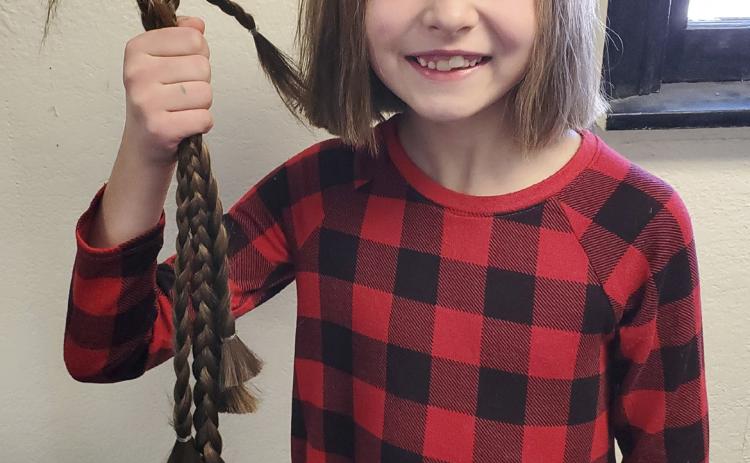 Mullen Elementary second grader Lillian Ericksen recently donated 14 inches of her hair to Wigs for Kids. Wigs are custom made with human hair and donated to children with various medical conditions. It was a little tough to make the drastic cut (little sister cried while watching big sis get the hair cut). But they discussed that it was a small inconvenience compared to what some other kids are experiencing. Awesome, Lillian! Alicia Ericksen