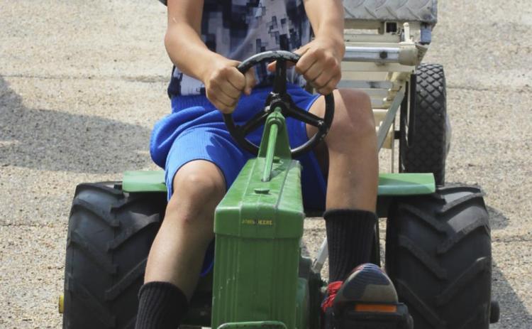 Teal Peterson gives it his all in the pedal tractor pull! Gerri Peterson