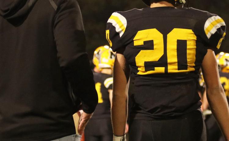Quarterback Bo Pettit, Jr., waits for the play call from Head Coach Wade Marsh last Thursday night. Carolee Brown Photography