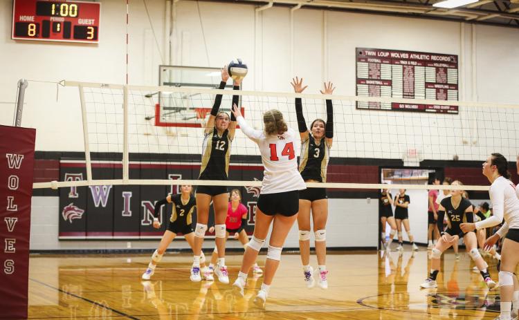 Allie Boyer with a block at the triangular in Taylor. Megan Andersen