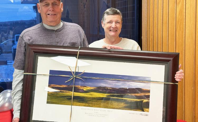 Sand Hills Golf Club honored two of their long-time employees who retired this year with an open house on Sunday, Nov. 30. Carol Wright, pictured with her husband John G., was the Laundry Supervisor since Aug. 3, 2001. Clint Svoboda