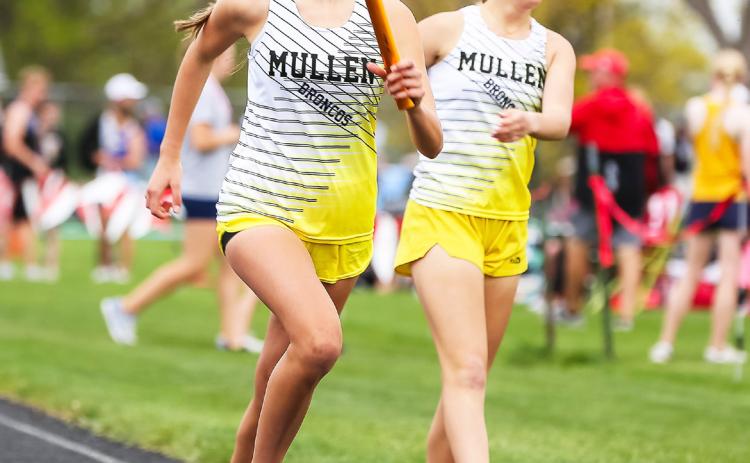 Ady Hampton starts her leg of the 4x8 relay at Sutherland after getting the baton from Riley Hegland. Megan Andersen