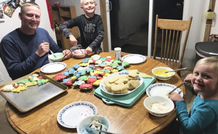 Dane, Teal and Danielle Peterson decorating Christmas cookies last year on Christmas Day. Gerri Peterson
