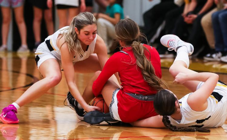 Peyton Paxton (left) and Kalli Licking go after a loose ball last week against Sutherland. Megan Andersen