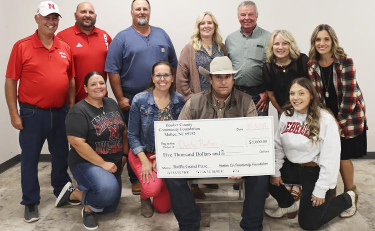 Dusty Paxton and his big check with Hooker County Community Foundation board members, back-r: Ron Boyer, Casey Phillips, Larry Ridenour, Yvonne Andrews, Kirk Jacobs, Barb Svoboda, Kara Connealy. Front: Stacy Kraye, Gerri Peterson, Dusty, Addie Lovitt. Not pictured: Mary Lou Harding, Scott Jones, George Vinton. Paxton donated his winnings to Hooker County Transit. Shirley Osborn
