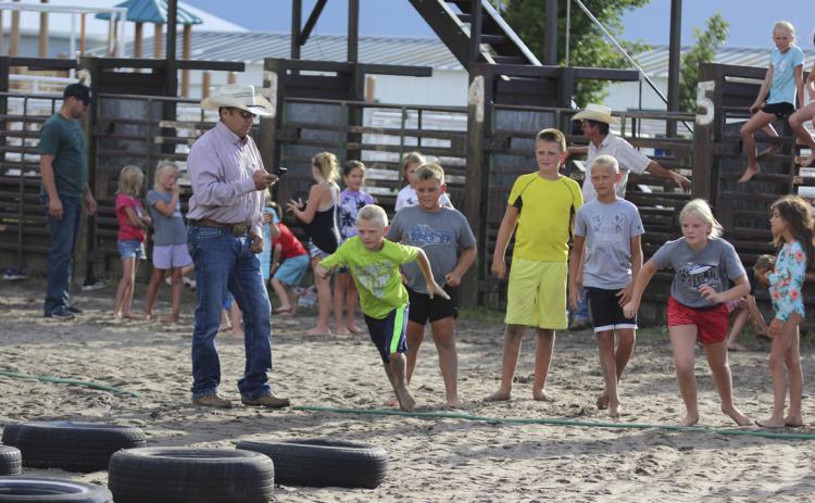 Weston Ourada and Ava Walz start the Obstacle Course Monster Slip &amp; Slide relay race for their teams. Gerri Peterson