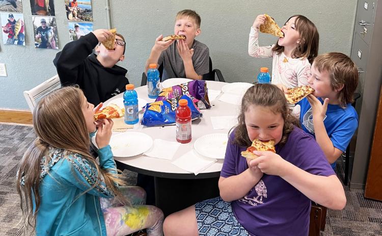 Clockwise around table from back left: Cooper Cash, Gus Wingebach, Nora Pohot, Kayden Evans, Kaleah Heaton, Abbigail Mundorf. Brett Mauler