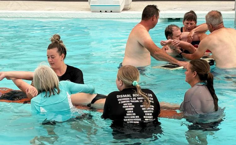 After a thunderstorm cut the pool barbecue short, the lifeguards and EMTs were eventually able to get into the pool with trainer Mike Bailey last Monday evening, July 28. Sarah Hardin
