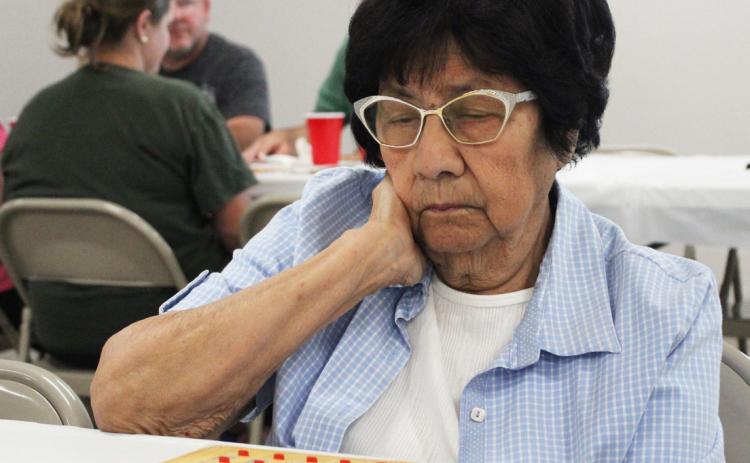 Gerri Peterson Mary Lou Isom keeps an eye on her Bingo card last Wednesday.