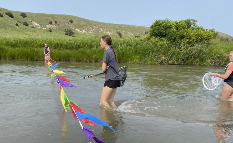 L-r: Ava Walz, Harper Andersen and Maci Walz prepare to catch the rubber ducks as they come across the finish line last month during the FCCLA Duck Race. Kelli Walz