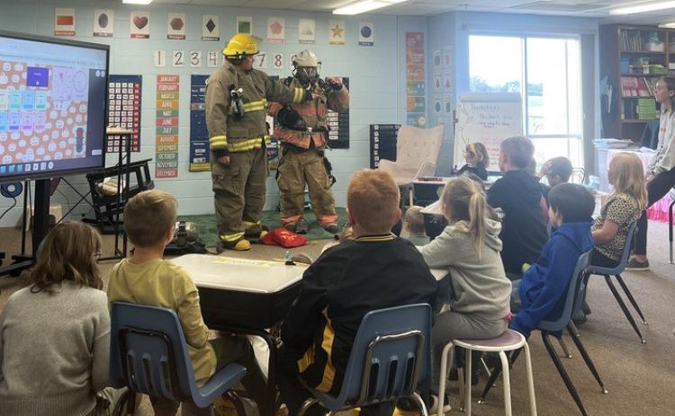 Mullen Volunteer Fire Department’s Jason Brown and Chris Wurm visited Mullen Elementary last Monday, Oct. 6 to talk about fire safety. Students got a fire truck tour and were able to try on gear. courtesy photo